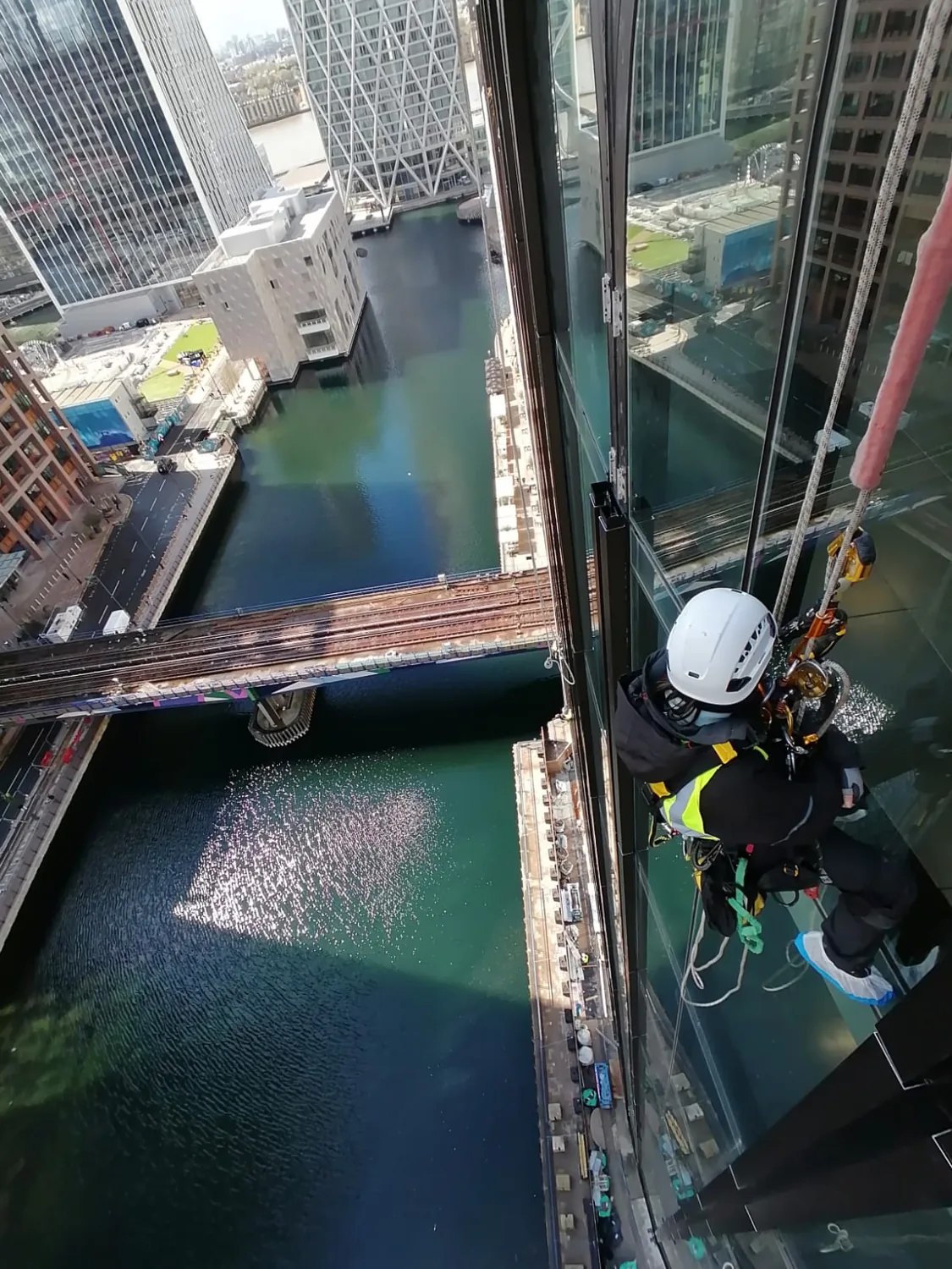 Rope access alongside a glazed façade.