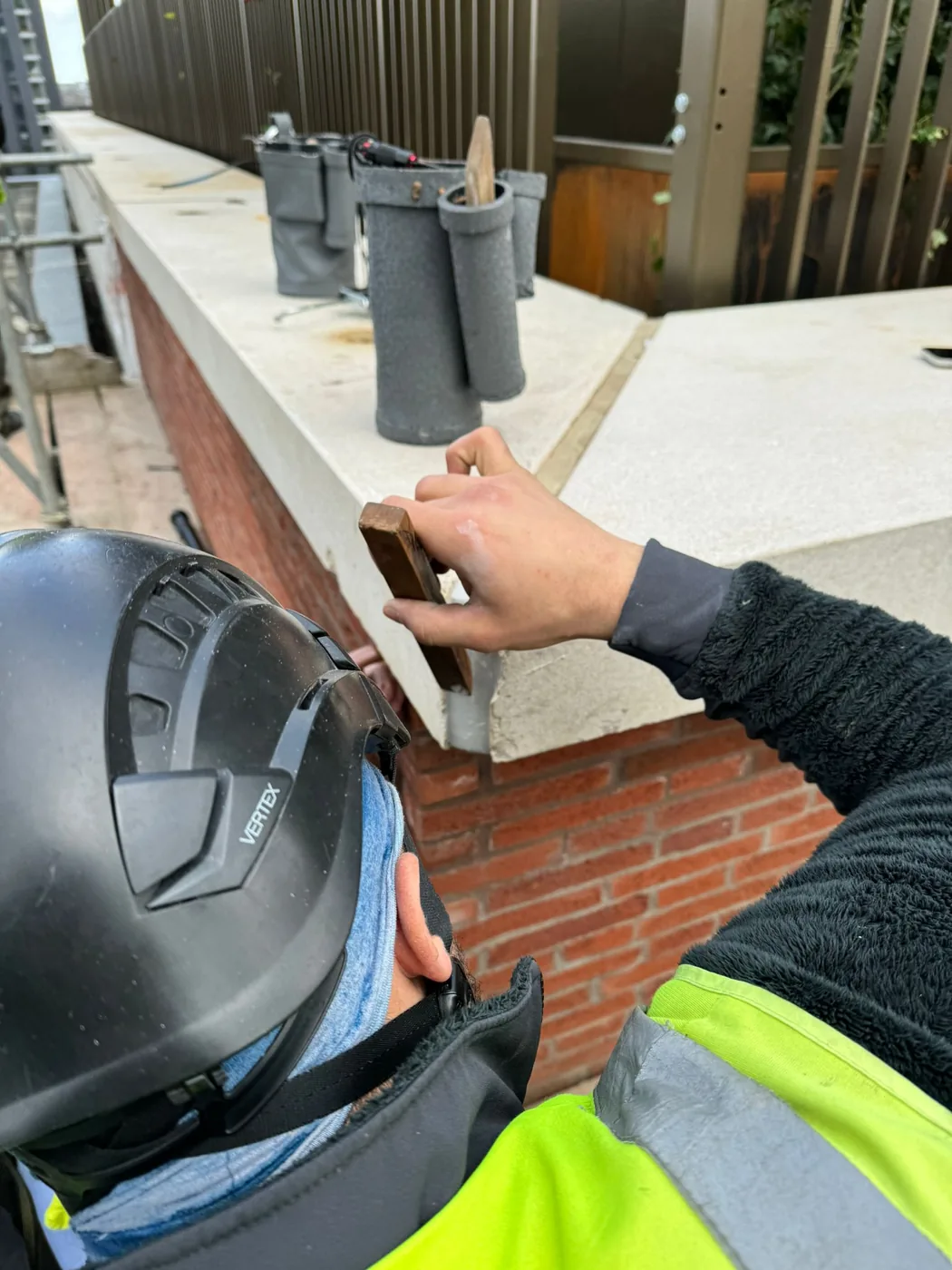 Tooling sealant at an external coping joint.
