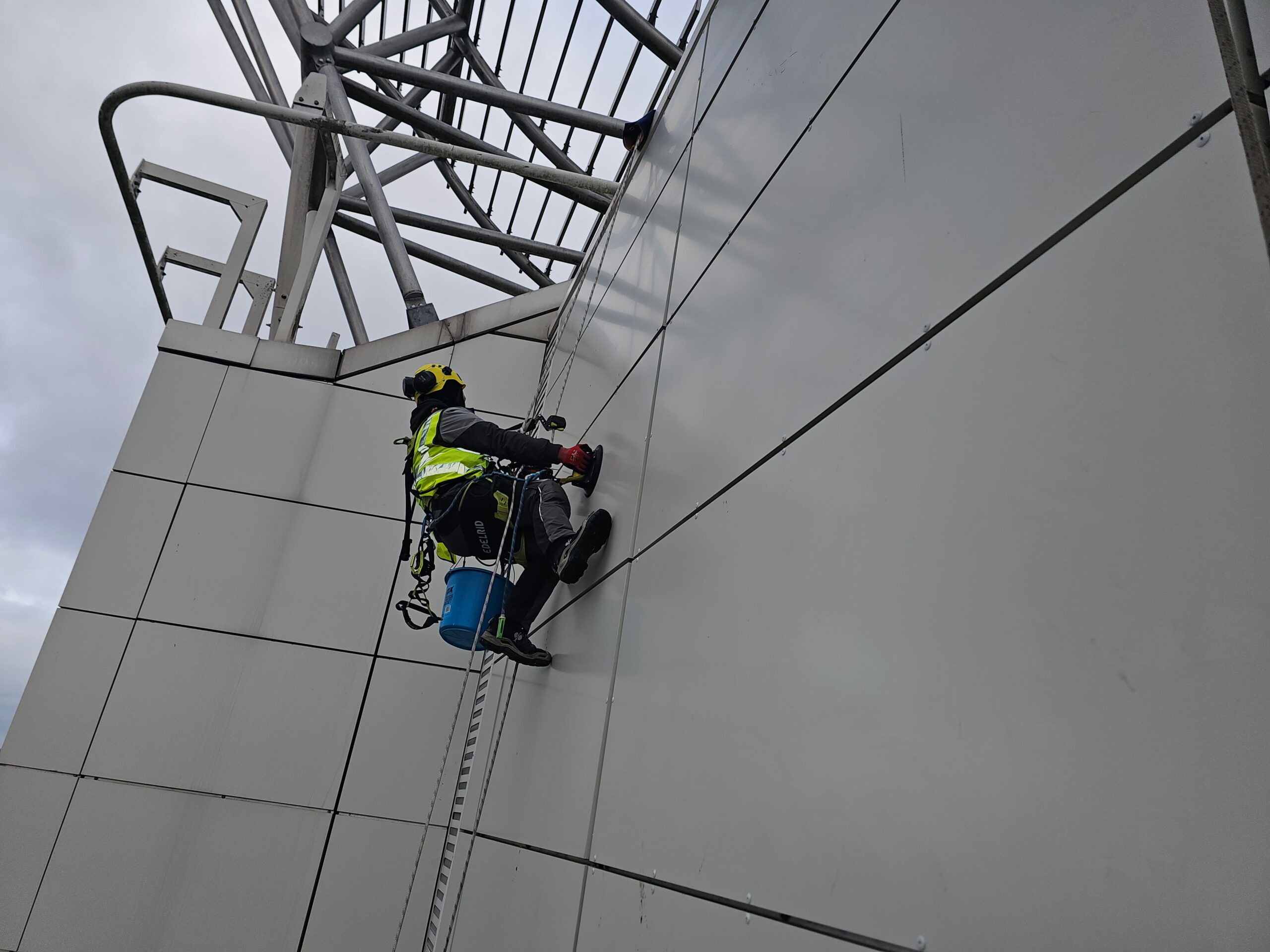 Technicians performing external access works on a modern commercial building façade.
