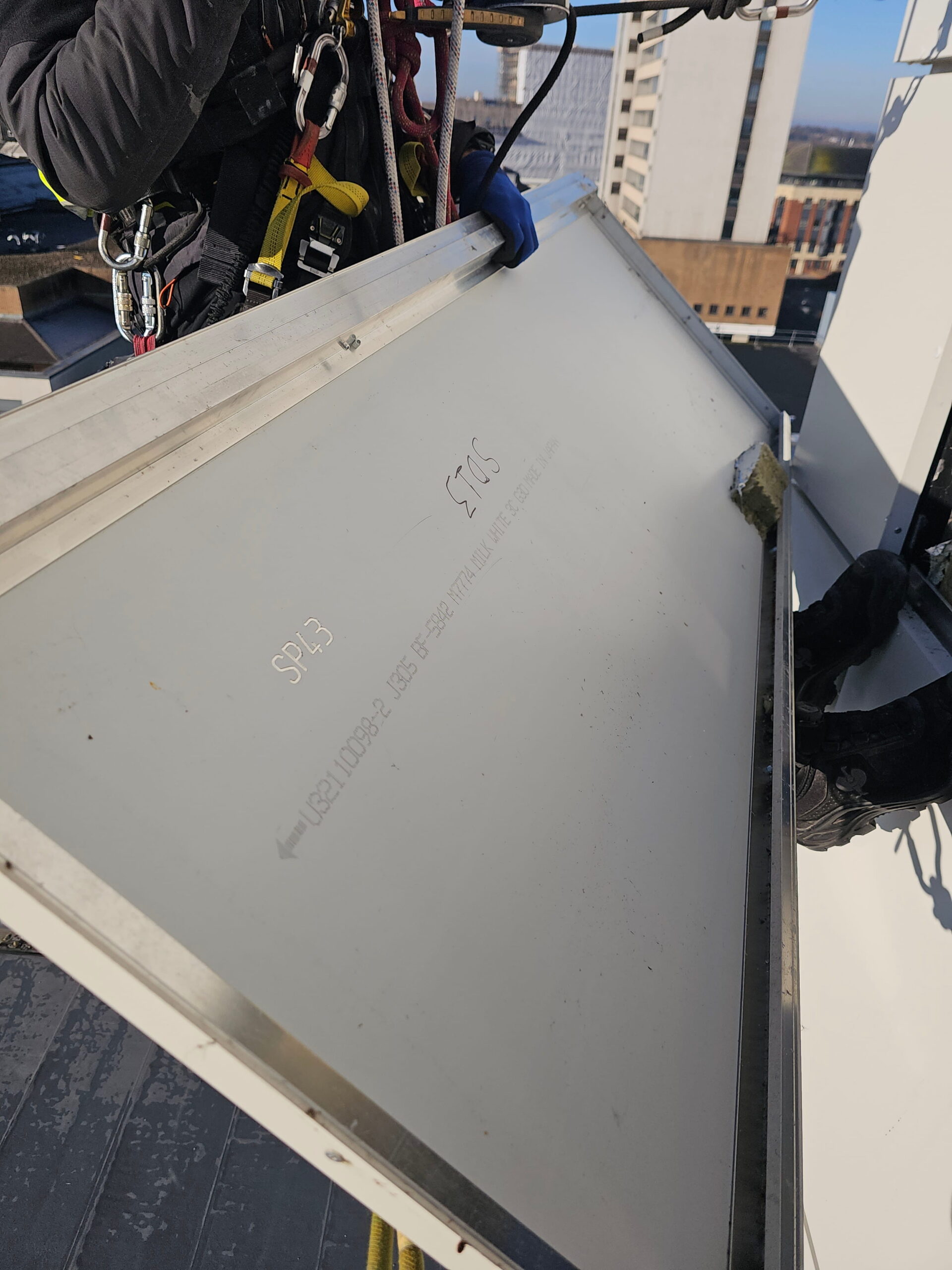 Technicians coordinating rope access activities on a live commercial building site.