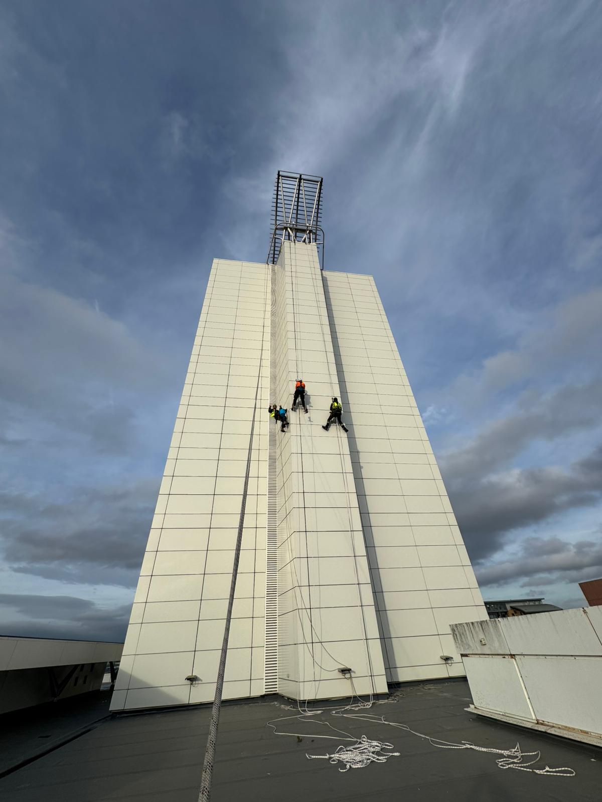 High-rise rope access operations supporting façade maintenance on a commercial building.